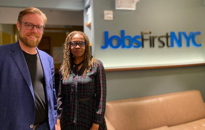 Marjorie Parker and Sean Hinton stand in the JobsFirstNYC lobby.